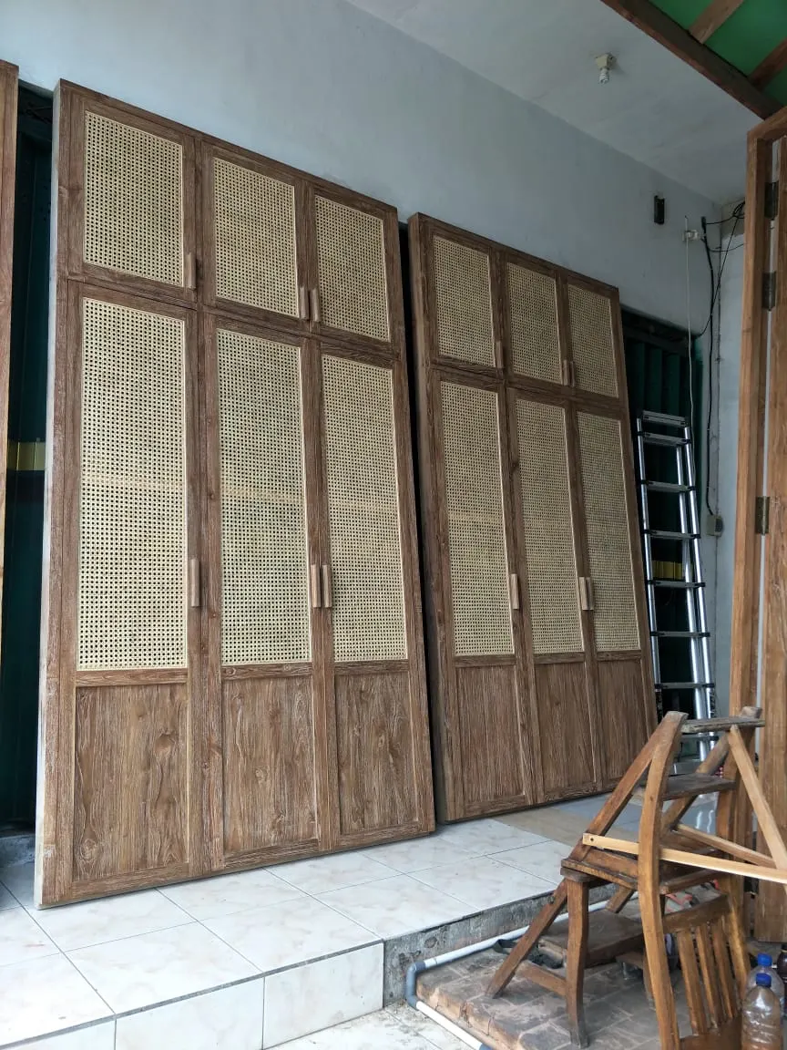 Façade de portes en teck et cannage, posée sur chantier
