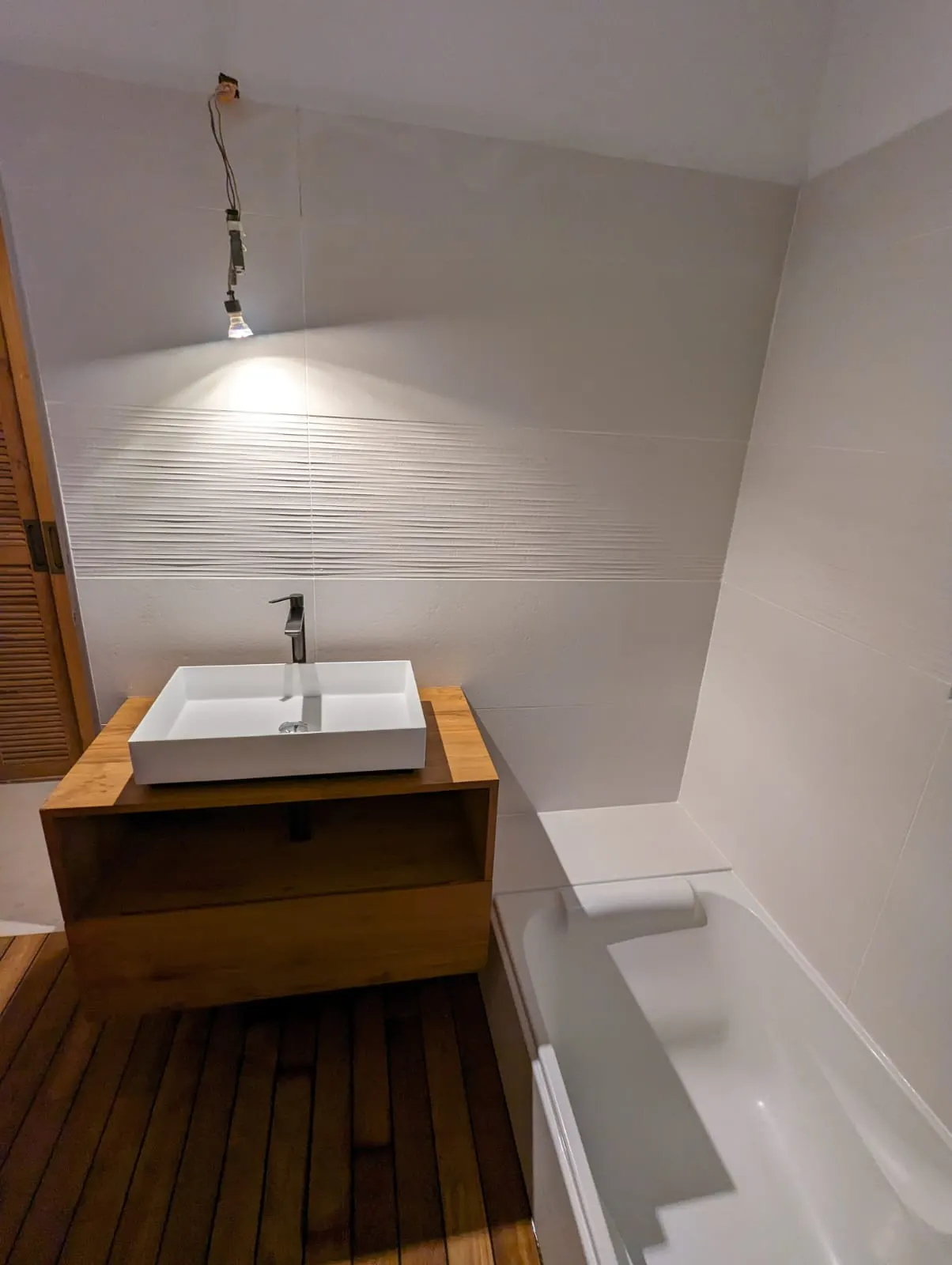 Salle de bain : meuble vasque suspendu en teck, plancher façon pont de bateau